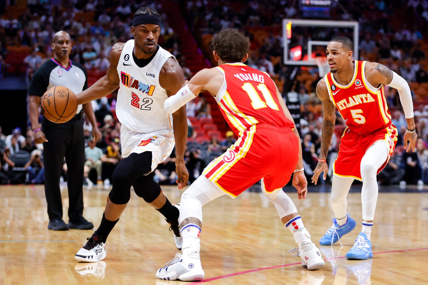 Hawks guards Trae Young and Dejounte Murray defend Heat forward Jimmy Butler.